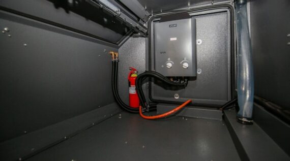 Gas geyser with water connections in the Conqueror Comfort Platinum Edition off-road camper trailer