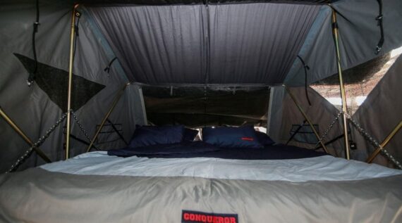 Large, comfortable sleeping area featuring a massive king-size bed in the Conqueror Comfort Platinum Edition off-road camper trailer