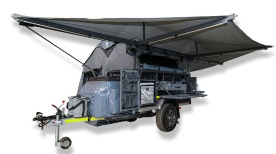Side view of the off-road camper trailer with awning above the kitchen compartment